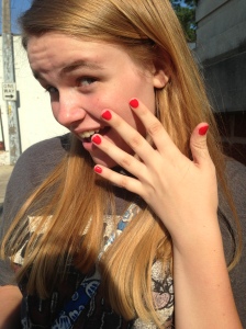 Modeling her tomato-y nails. 